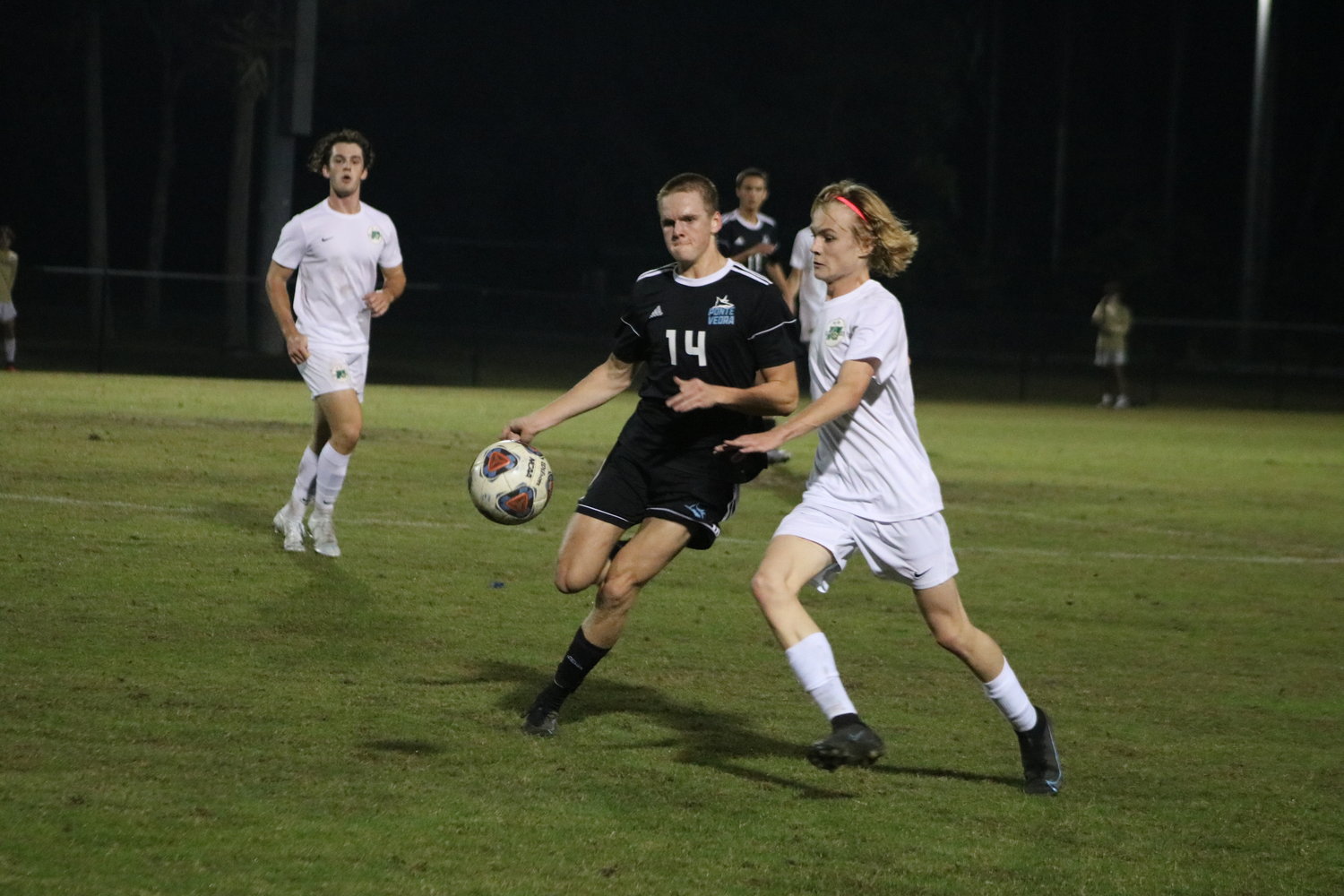 Ponte Vedra’s Cooper Gottfried (No. 14) and Josh Sintich of Nease chase down a ball.